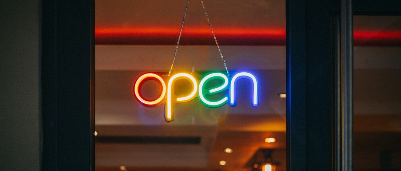 A business door with a sign written "open"